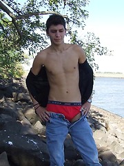 Handsome twink guy posing for the camera outdoors