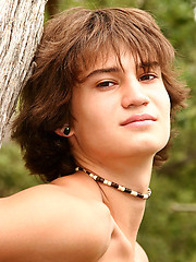 Naked long-haired boy posing outdoor