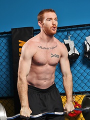 Sporty redhead dude workout in the gym