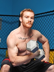 Sporty redhead dude workout in the gym