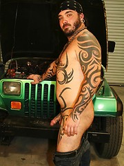 Tattooed bad boy Rock Ramsey strips down and strokes his hard dick for the camera.